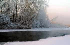 ice, water and water vapour on a river in winter