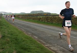 man leading a road race